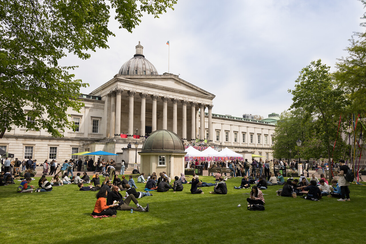Modern UK university library entrance with students on the lawn